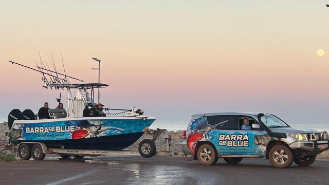 Barra or Blue Fishing Charters boat and branded four wheel drive at the Dundee Beach boat ramp at sunrise