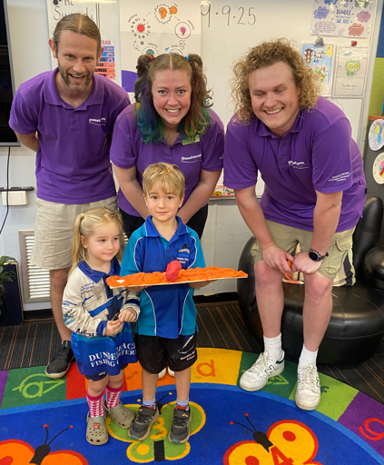 Young children on the classroom mat with staff at Dundee Beach School