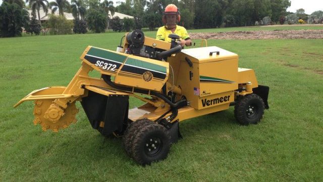 Xtreme Garden Care operator on a Vermeer stump grinder for stump removal